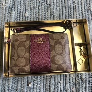 Brand  New Coach Clutch with two gold charms
